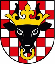 Herb Powiatu Kaliskiego. Przedstwia czarną głowę tura w koronie i z pierścieniem w nozdrzach. Symbol umieszczony jest na czerwono białym polu szachowanym.